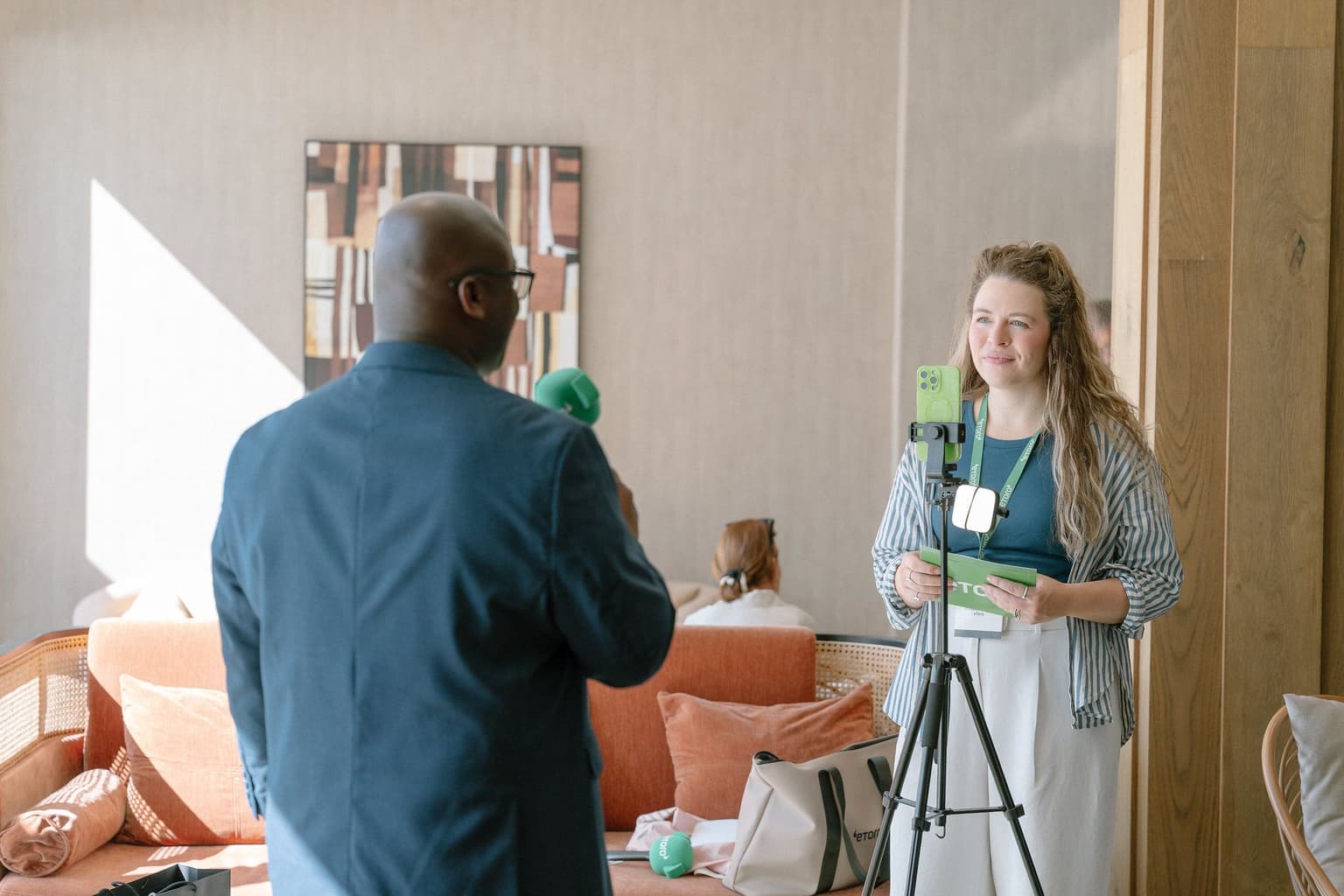 An attendee filming a video interview at the 2025 summit