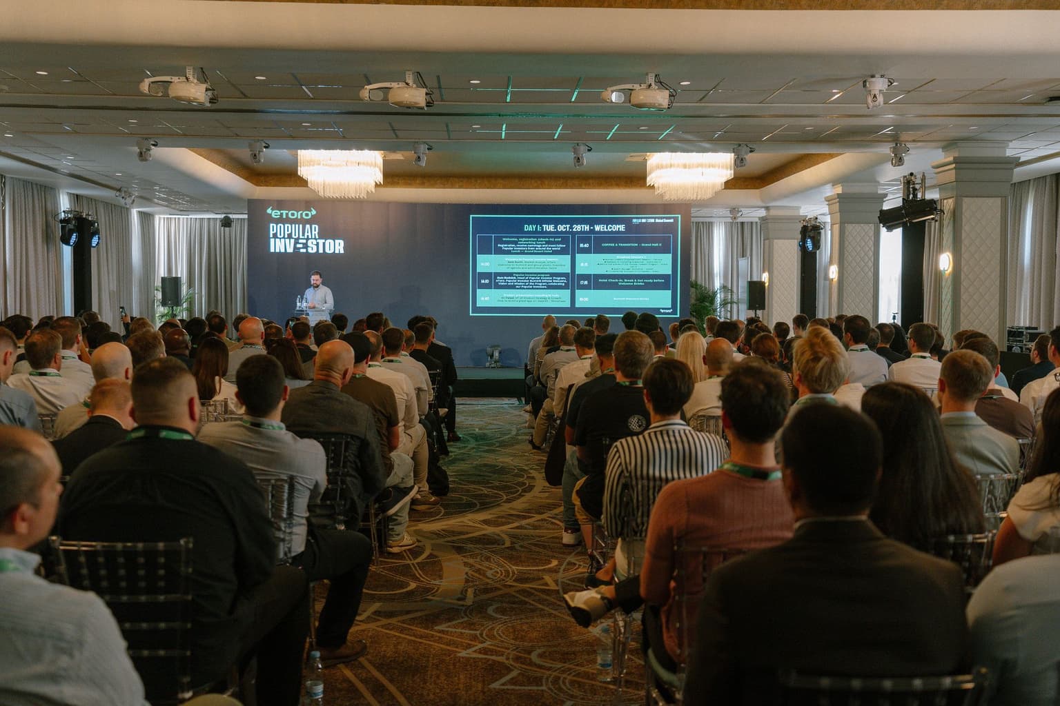A full room facing the main stage at the 2025 summit